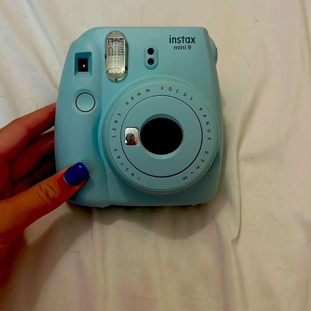 Blue polaroid camera with case and accessories
